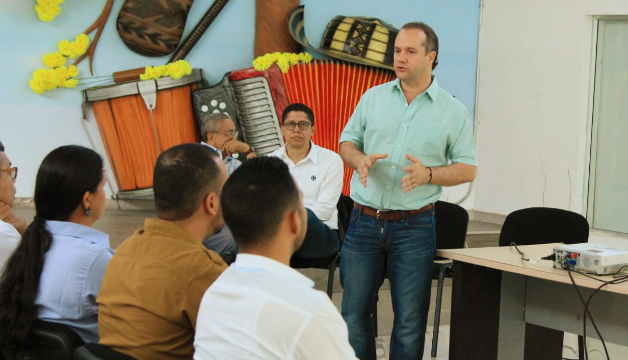 Un funcionario habla de pie ante los participantes sentados en el taller del Plan de Acción