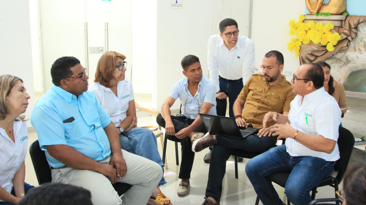 Participantes conversan en un grupo de trabajo sentados en sillas